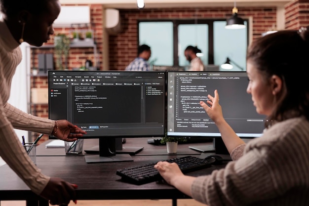 Multi ethnic tech enginners developing html code and cloud computing in it development agency. Cloud developer working on database programming with html script, computing big data.