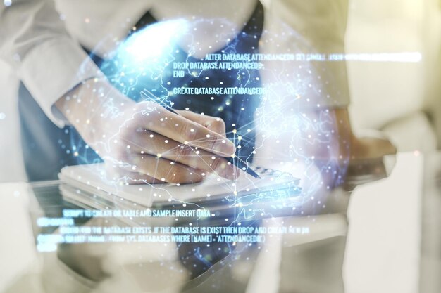 Multi exposure of abstract graphic coding sketch with world map and man hand writing in diary on background big data and networking concept