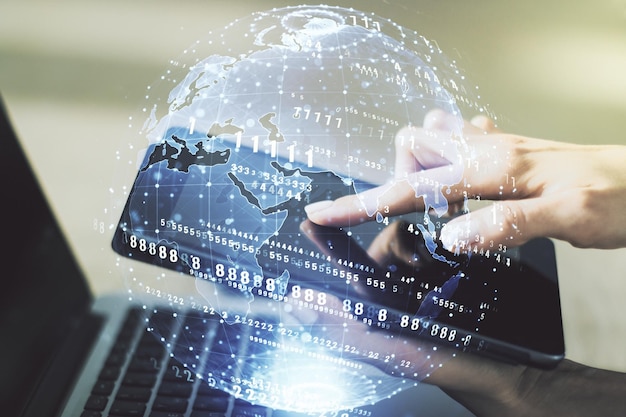 Multi exposure of abstract software development hologram with world map and finger presses on a digital tablet on background global research and analytics concept
