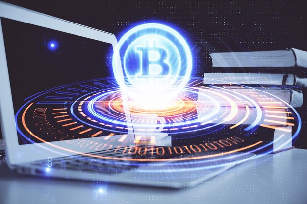 Multi exposure of blockchain and crypto economy theme hologram and table with computer background Concept of bitcoin cryptocurrency