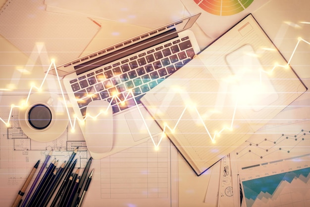 multi exposure of forex chart drawing over table background with computer concept of financial research and analysis top view