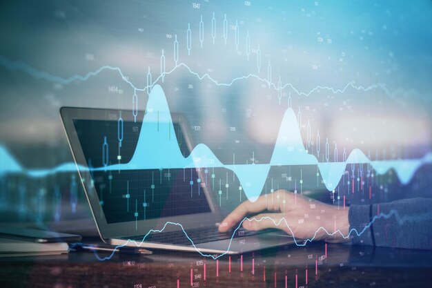 Multi exposure of stock market graph with man working on laptop on background Concept of financial analysis