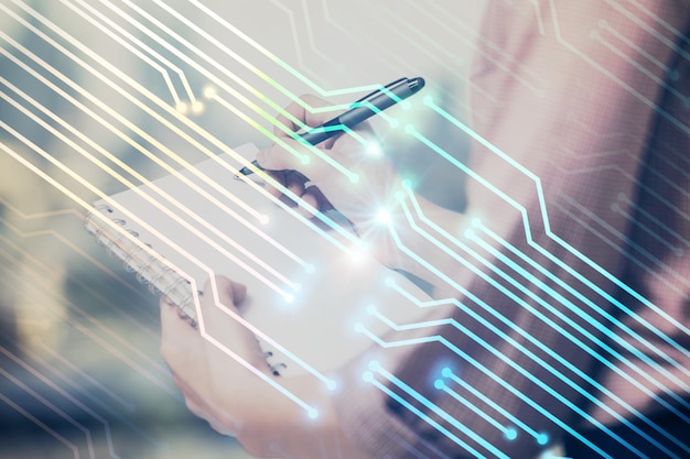 Multi exposure of womans writing hand on background with data technology hud Concept of innovation