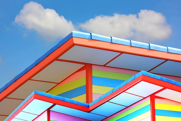 Multicolor roof and buiding exterior design blue ske white cloud