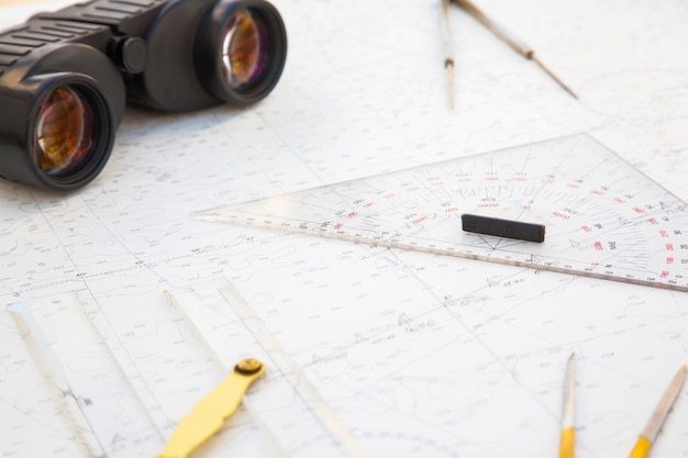 Navigation tools are on the navigation map Plotter divider ruler binoculars and pencil