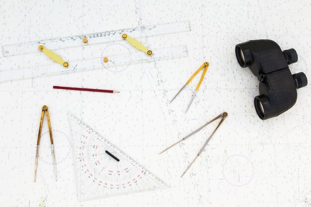 Navigation tools are on the navigation map Plotter divider ruler binoculars and pencil