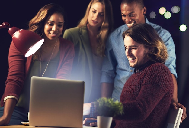 Night journalists and teamwork on laptop in office for journalism group or helping with article Happy people talking and online for column research on news reporters or support advice in overtime