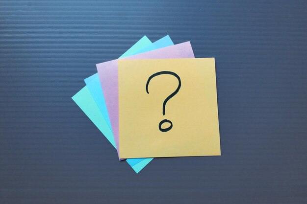 note paper with question mark on textured background