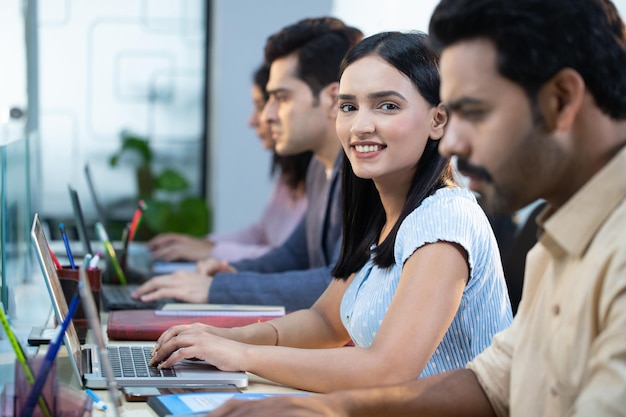 Office Colleagues In Office Female Smiling While Looking At Camera