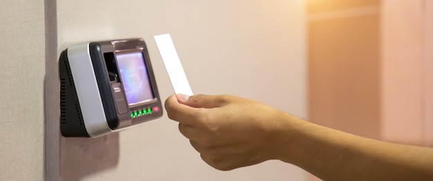 Office man using the id card to scan at the access control.