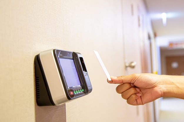 Office man using the id card to scan at the access control.