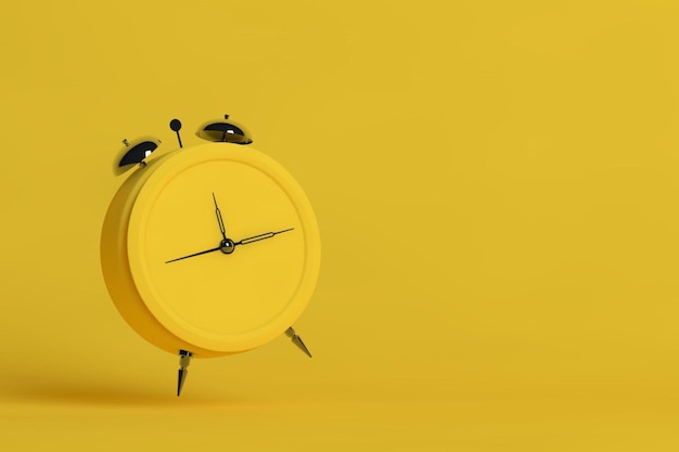 Old alarm clock on yellow background