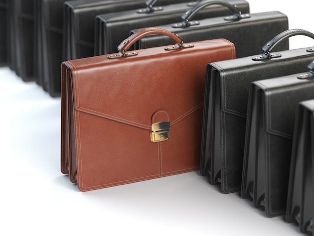 one unique brown briefcase in the row of black briefcases