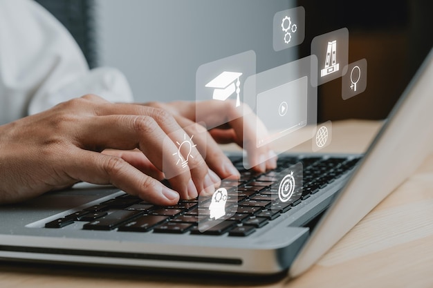 Online education training Woman using laptop on adesk table with VR screen education icon background webinar online