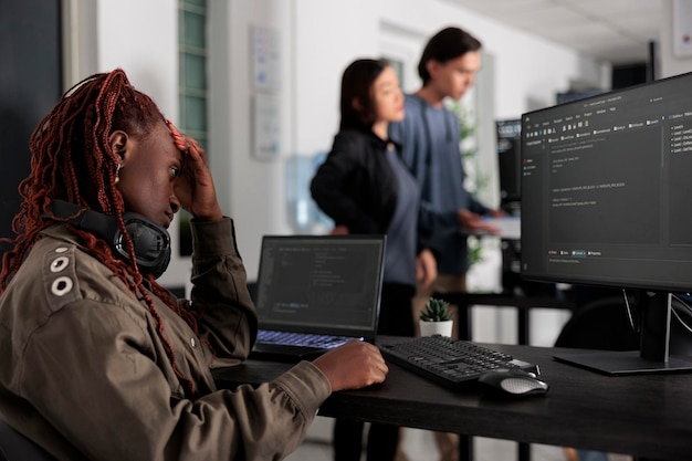 Pensive system engineer thinking at programming ideas trying to write html code and create new interface in data room. Web developer working at database in artificial intelligence developing agency.