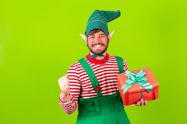 photo of young boy santa's helper dressed as elf holding a gift box