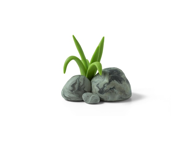 Pieces of stones with cracked texture and grass made of plasticine Handmade stones with clay