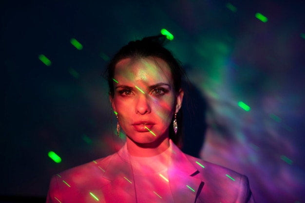 portrait of beautiful young woman against illuminated background