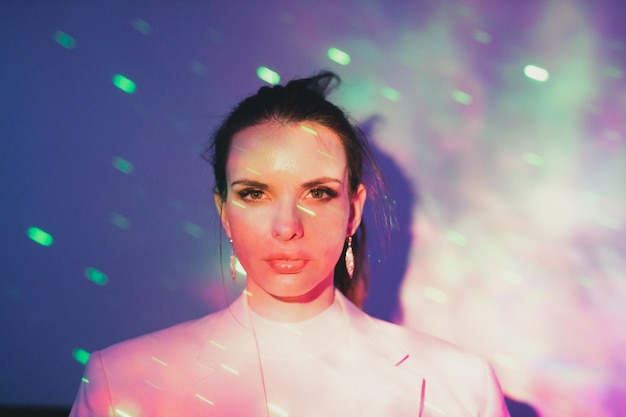 portrait of beautiful young woman in illuminated lights