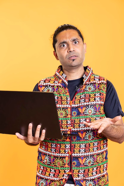 Portrait of man shocked after seeing error message on laptop screen