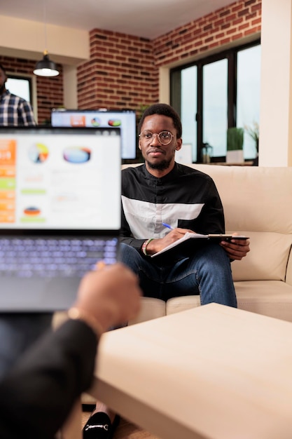 Portrait of man using laptop at home