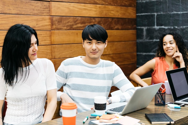 Portrait of man with coworkers working in office