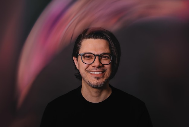 Portrait of smiling mature man wearing eyeglasses with light effect