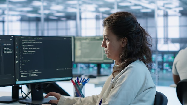 portrait of smiling technician programming in ai data center