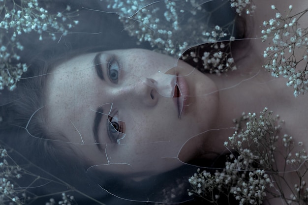 portrait of woman seen through broken glass