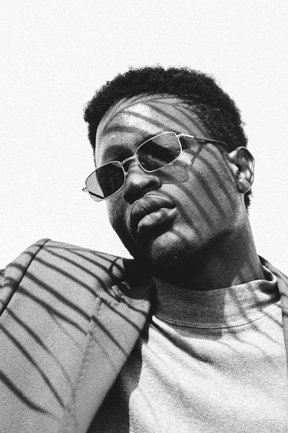 portrait of young man wearing sunglasses against sky