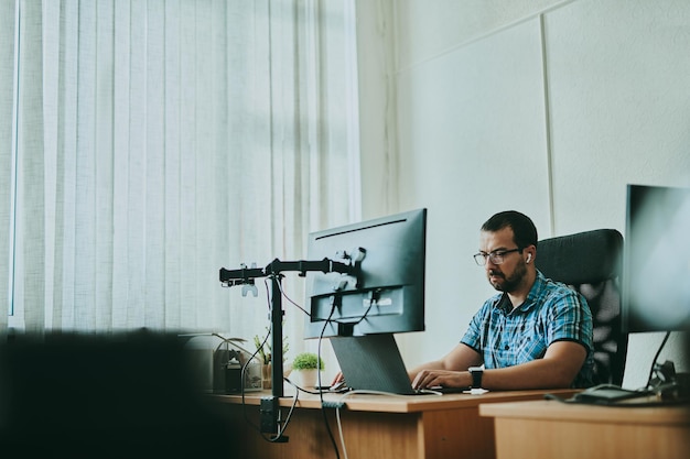 Portrait professional man programmer working concentrated on computer in diverse offices Modern IT technologies development of artificial intelligence programs applications and video games concept