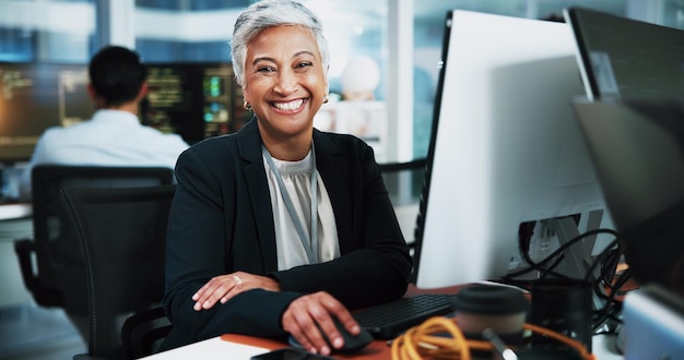Portrait woman and developer with computer in office for programming software update and IT career Mature person pc and coding pride for website development testing server and system application