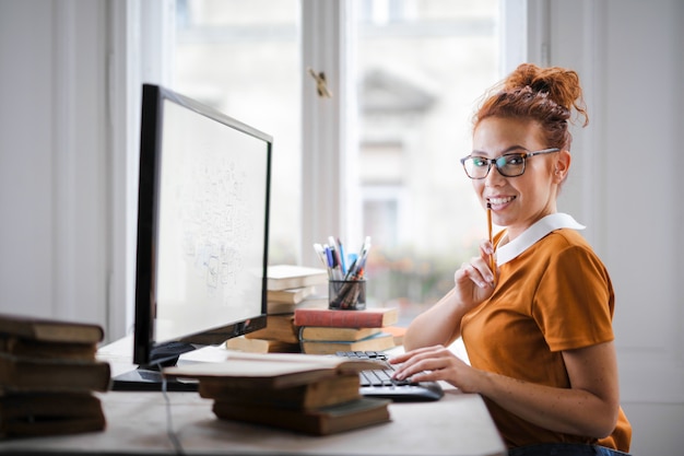 Pretty young woman working on a computer