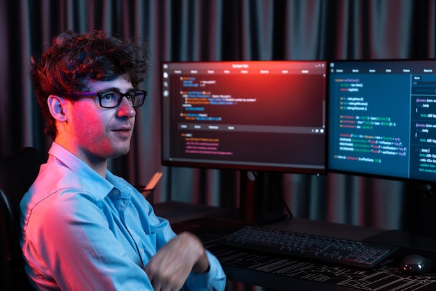 Profile of IT developer sitting against on software codding monitor Gusher