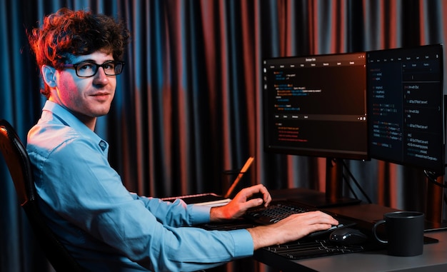 Profile of IT developer sitting against on software codding monitor Gusher