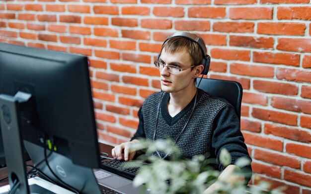 Program development concept Young man working with computer