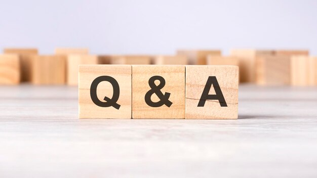 Q and A word concept written on wooden cubes or blocks on a light background