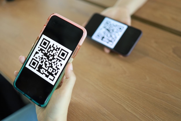 Qr code payment Woman scanning QR code online shopping cashless technology concept