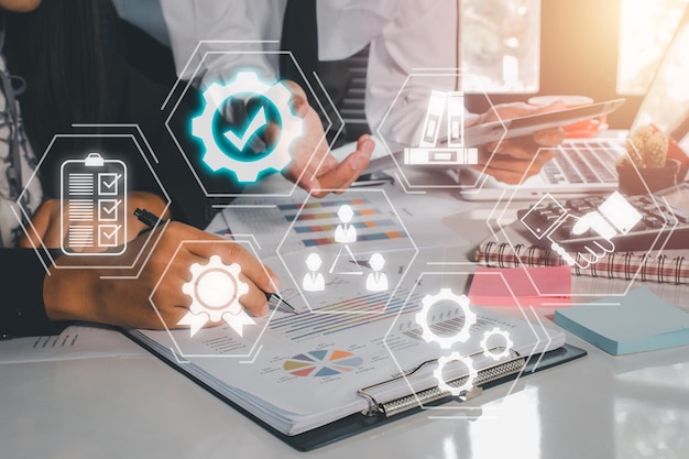 Quality management with QA assurance QC control and improvement Business team discussing data with document data with VR screen quality management icon on desk table