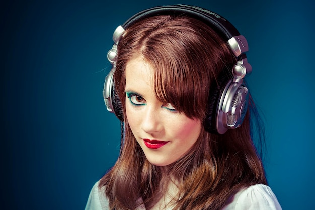 redhead teenager listening to rock music headphones