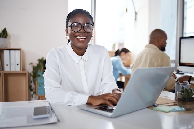 Shot of a young businesswoman using a laptop in a modern office