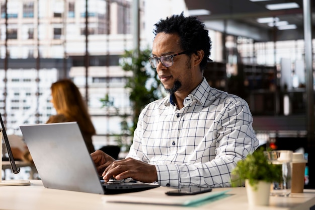 Skilled businessman at his office desk working on report writing