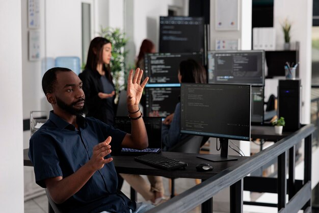 Software developer checking source code using ar hologram, working with augmented reality and html script. system engineer checking holographic database writing ai algorithm in software office.