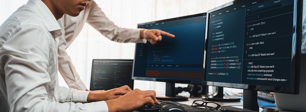 Software development team working together in office coding script display on computer monitor Programmer and software engineer working in tech developer company Trailblazing
