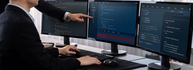 Software development team working together in office coding script display on computer monitor Programmer and software engineer working in tech developer company Trailblazing