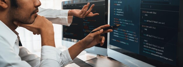 Software development team working together in office coding script display on computer monitor Programmer and software engineer working in tech developer company Trailblazing