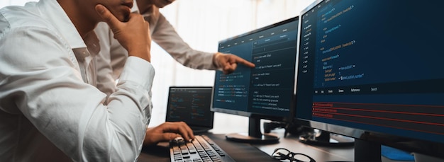 Software development team working together in office coding script display on computer monitor Programmer and software engineer working in tech developer company Trailblazing