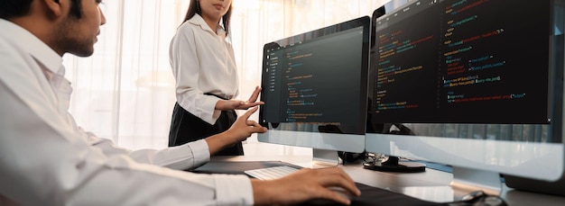 Software development team working together in office coding script display on computer monitor Programmer and software engineer working in tech developer company Trailblazing