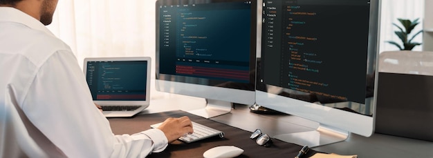 Software engineer working on application development on his computer display code and script on monitor at tech company office workplace Application developer solving and writing code Trailblazing