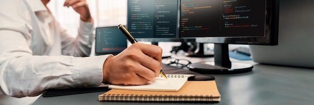 Software engineer working on application development on his computer display code and script on monitor at tech company office workplace Application developer solving and writing code Trailblazing